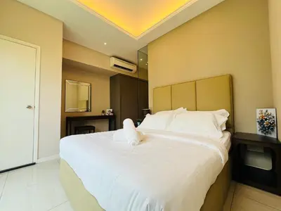a bedroom with a large bed with white sheets at Dorsett Sri Hartamas by DeUrban in Kuala Lumpur