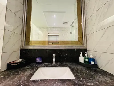 a bathroom sink with a large mirror above it at Dorsett Sri Hartamas by DeUrban in Kuala Lumpur