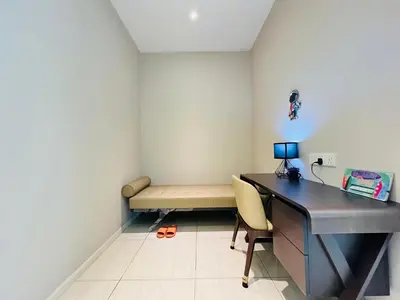 an office with a desk and a bench in a room at Dorsett Sri Hartamas by DeUrban in Kuala Lumpur
