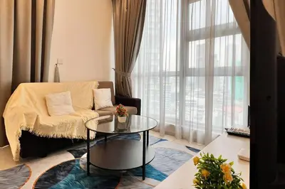 a living room with a couch and a glass table at The Robertson Bukit Bintang by DeUrban in Kuala Lumpur
