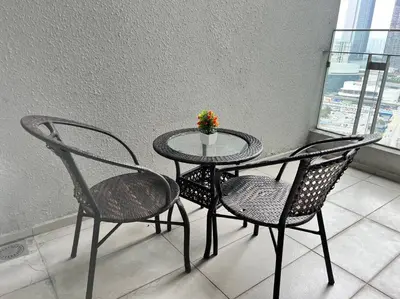 a table with two chairs and a table with a plant on it at The Robertson Bukit Bintang by DeUrban in Kuala Lumpur