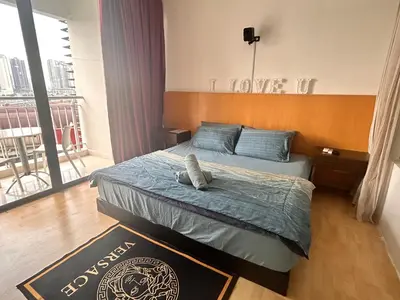 a bedroom with a bed in a room at Private Cinema and Jacuzzi at Pertama Residency in Kuala Lumpur