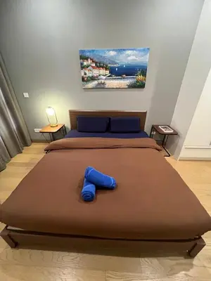 a bedroom with a large bed with blue pillows at Lucentia Residence Bukit Bintang by Ideal Homes in Kuala Lumpur