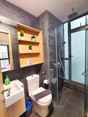 a bathroom with a shower and a toilet and a sink at The Luxe Colony KLCC BY Infinitum in Kuala Lumpur