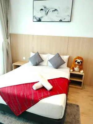 a bedroom with a large bed with a teddy bear at The Luxe Colony KLCC BY Infinitum in Kuala Lumpur
