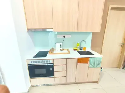 a small kitchen with a sink and a microwave at The Luxe Colony KLCC BY Infinitum in Kuala Lumpur