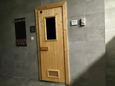 a wooden door in a room with a wall at Riveria City KL Sentral by Jane in Kuala Lumpur