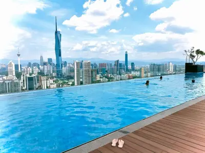 a swimming pool on the roof of a building with a city at Riveria City KL Sentral by Jane in Kuala Lumpur