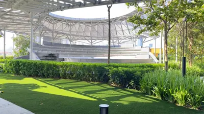 a stadium with a grass field and benches at Cozy studio service suite Free parking Netflix Trion B5206 KL in Kuala Lumpur