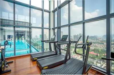 a gym with a swimming pool in a building at Novo Kuala Lumpur by Cobnb, Jalan Ampang in Kuala Lumpur