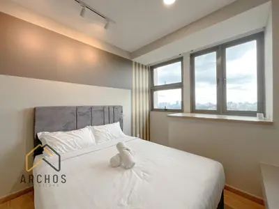 a bedroom with a large white bed with windows at Riveria City Kuala Lumpur Sentral by Archos in Kuala Lumpur