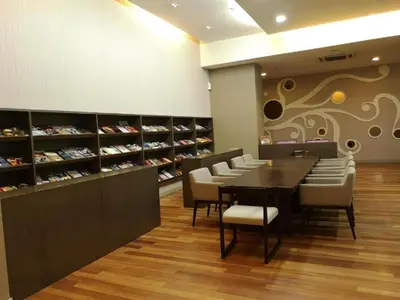 a dining room with a table and chairs in a store at Infinity Pool Hostel in Kuala Lumpur
