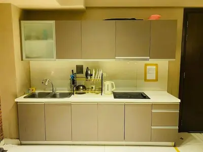 a kitchen with a sink and a counter top at Infinity Pool Hostel in Kuala Lumpur