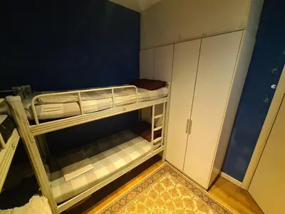 a room with two bunk beds and a cabinet at KL Infinity Pool Hostel in Kuala Lumpur