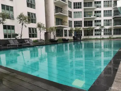 a large swimming pool in front of a building at Infinity View KL Hostel in Kuala Lumpur