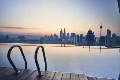 a view of a city skyline from a swimming pool at Celestial Heights Hostel featuring Infinity Skypool in Kuala Lumpur