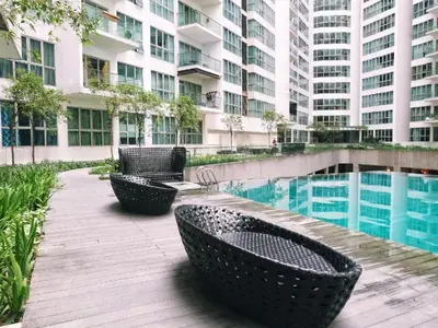 a patio with chairs and a pool in a building at Celestial Heights Hostel featuring Infinity Skypool in Kuala Lumpur