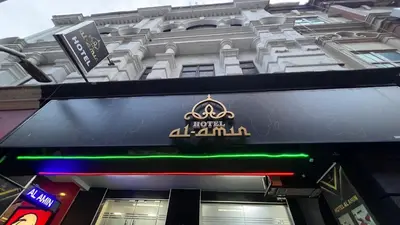 a sign for a hotel in front of a building at Hotel AL Amin By Ahmed in Kuala Lumpur