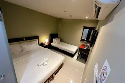 a hotel room with a bed and a small room with a bed and a small at Hotel AL Amin By Ahmed in Kuala Lumpur