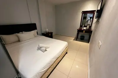a bedroom with a bed with a towel on it at Hotel AL Amin By Ahmed in Kuala Lumpur