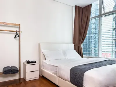 a bedroom with a bed and a large window at Sky Suite KLCC in Kuala Lumpur