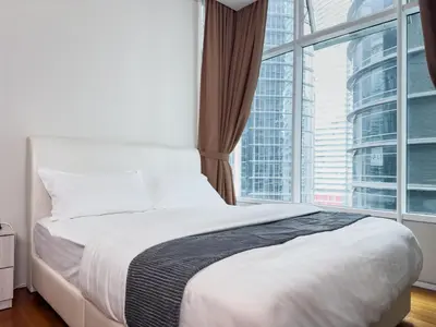a bedroom with a bed and a large window at Sky Suite KLCC in Kuala Lumpur