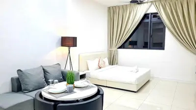 a living room with a couch and a table at Chambers Suites KLCC By City Homes in Kuala Lumpur
