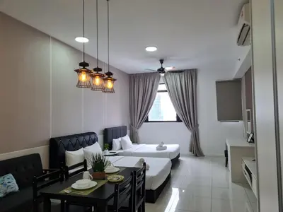 a hotel room with a bed and a dining table at Chambers Suites KLCC By City Homes in Kuala Lumpur