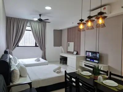 a living room with a bed and a dining room at Chambers Suites KLCC By City Homes in Kuala Lumpur