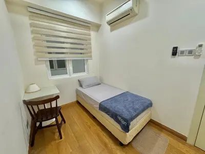 a bedroom with a bed and a chair and a window at ABC PRiVATE RooM Klcc in Kuala Lumpur