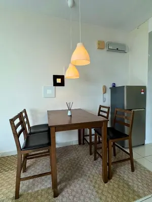 a dining room with a wooden table and chairs at ABC PRiVATE RooM Klcc in Kuala Lumpur