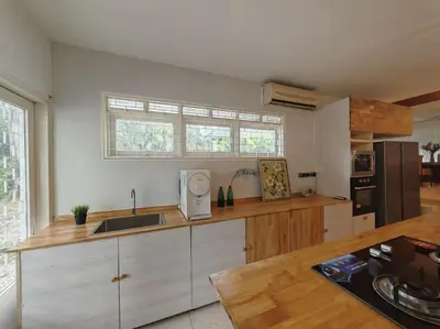 a kitchen with a sink and a counter top at Taman Duta KL Deluxe Villa by uBook in Kuala Lumpur