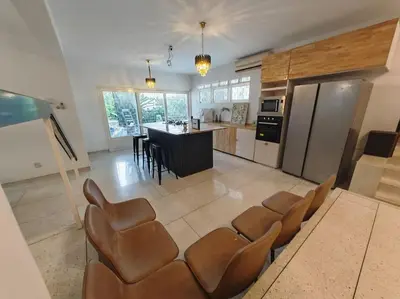 a kitchen with a bunch of chairs in a room at Taman Duta KL Deluxe Villa by uBook in Kuala Lumpur