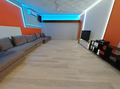 a living room with a couch and a tv at Taman Duta KL Deluxe Villa by uBook in Kuala Lumpur