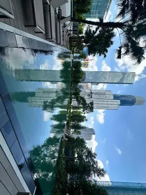 a reflection of a tree in a window of a building at Agile Bukit Bintang KLCC City Centre Kuala Lumpur Malaysia in Kuala Lumpur