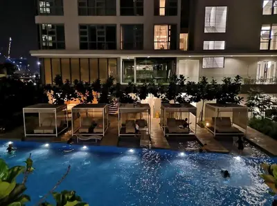 a view of a hotel at night with a swimming pool at Pool World at Robertson Residence Kuala Lumpur in Kuala Lumpur