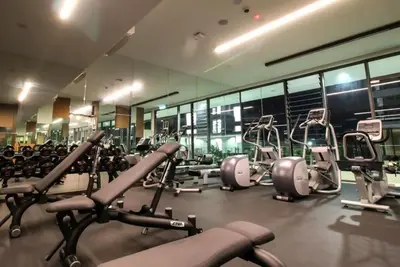 a gym with a lot of cardio machines in it at Pool World at Robertson Residence Kuala Lumpur in Kuala Lumpur