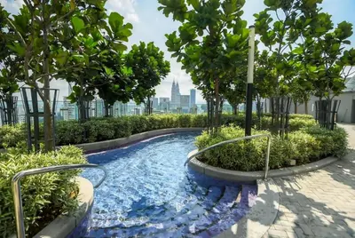 a swimming pool with trees and a city in the background at Pool World at Robertson Residence Kuala Lumpur in Kuala Lumpur