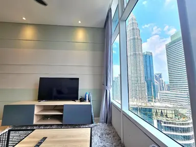 a room with a large window and a television at Apartment Sky by MonoSuites KLCC in Kuala Lumpur
