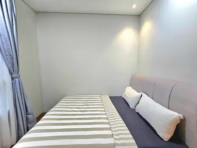 a bedroom with a bed and a window at Apartment Sky by MonoSuites KLCC in Kuala Lumpur