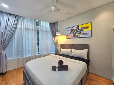 a bedroom with a bed with a hat on it at Apartment Sky by MonoSuites KLCC in Kuala Lumpur