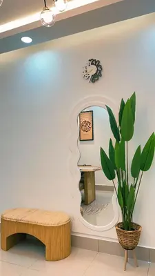 a room with a table and a bench and a mirror at Inara Homestay in Kuala Lumpur
