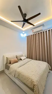 a bedroom with a bed with a ceiling fan at Inara Homestay in Kuala Lumpur