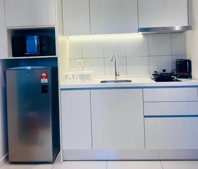 a white kitchen with a sink and a refrigerator at Chamber Suites By Kuala Lumpur in Kuala Lumpur