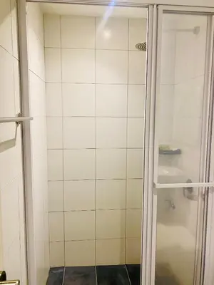 a shower with a glass door in a bathroom at Chamber Suites By Kuala Lumpur in Kuala Lumpur