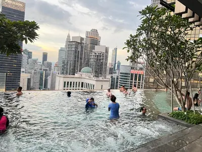 a group of people in a swimming pool in a city at AXON SUITES BUKIT BINTANG By KL PAVILION in Kuala Lumpur