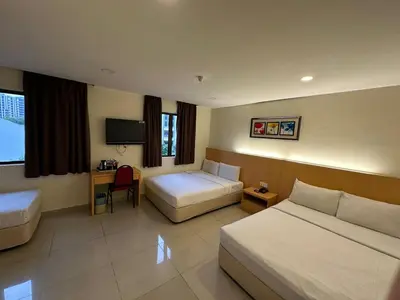 a hotel room with two beds and a television at South of The Clouds HOTEL KL Sentral \u5409\u9686\u5761\u5f69\u4e91\u4e4b\u5357\u9152\u5e97-\u4e2d\u592e\u8f66\u7ad9\u5e97 in Kuala Lumpur