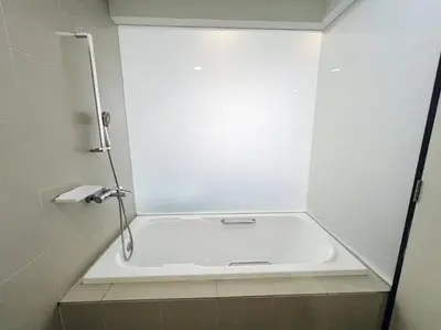 a shower with a white tub in a bathroom at PROMO Connected train 3 Bedrooms - Above Mall 25 in Kuala Lumpur
