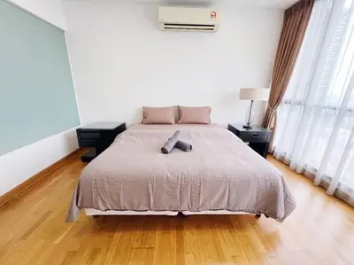 a bedroom with a large bed with two night stands at PROMO Connected train 3 Bedrooms - Above Mall 25 in Kuala Lumpur