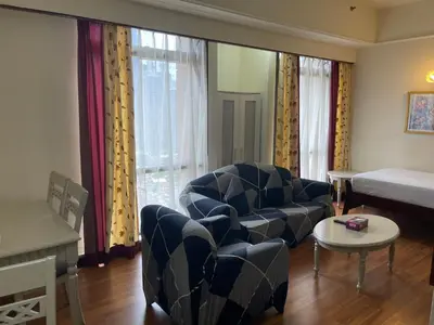 a living room with a couch and a bed at KL Elegant Apartment at Times Square in Kuala Lumpur